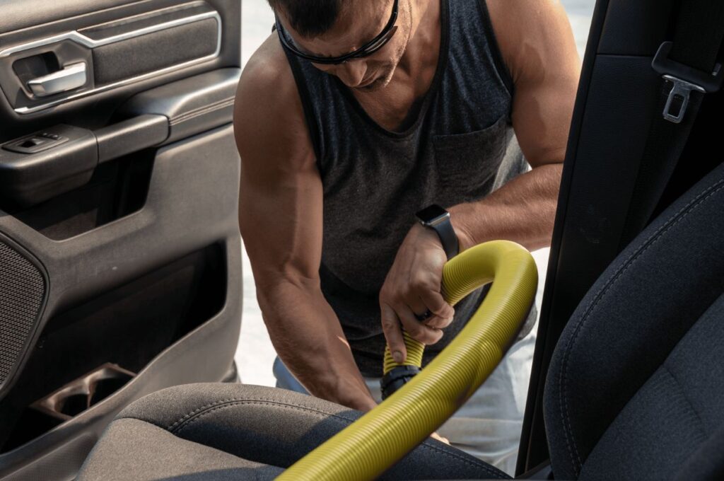 Customer vacuuming vehicle interior at Jax Kar Wash