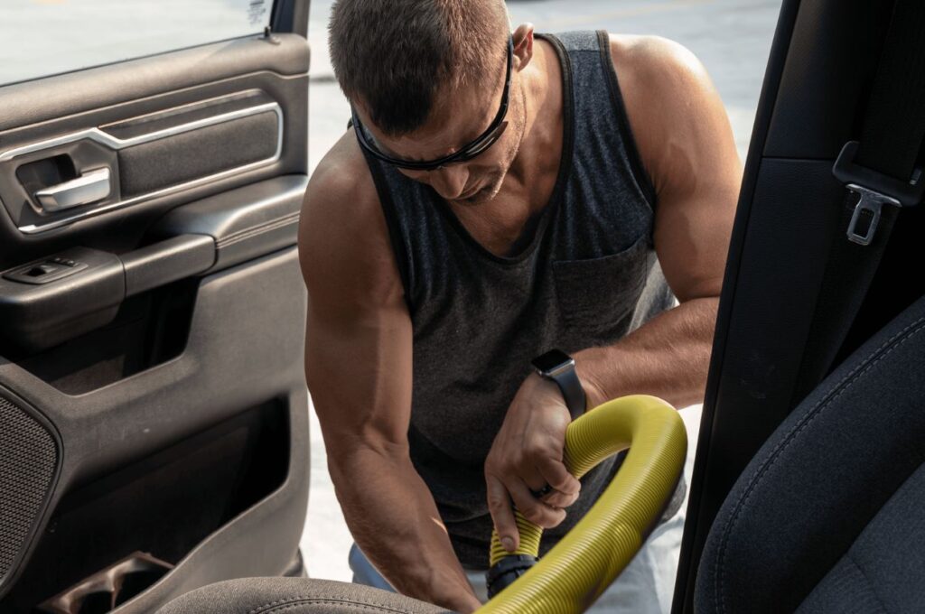 Customer vacuuming vehicle interior at Jax Kar Wash