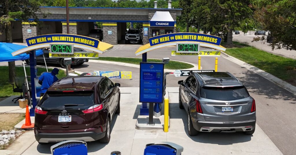 Two vehicles at Jax Kar Wash payment stations