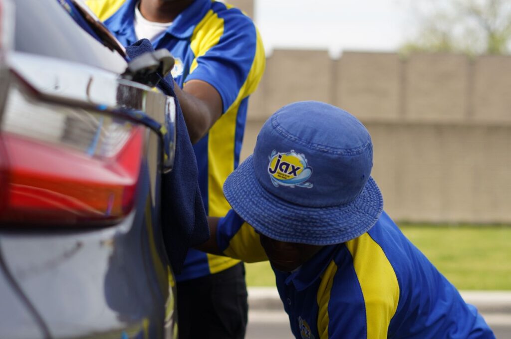 Jax Kar Wash staff hand drying vehicle exterior