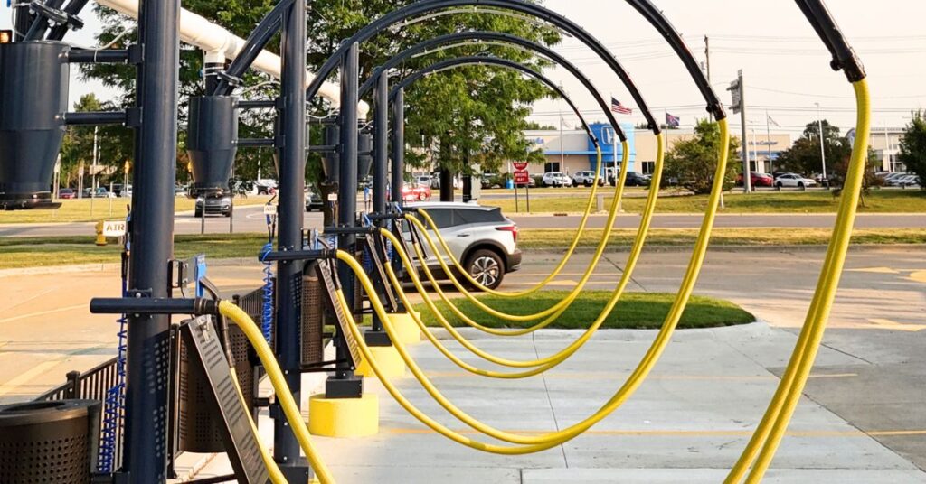 Row of yellow vacuum hoses at Jax Kar Wash station