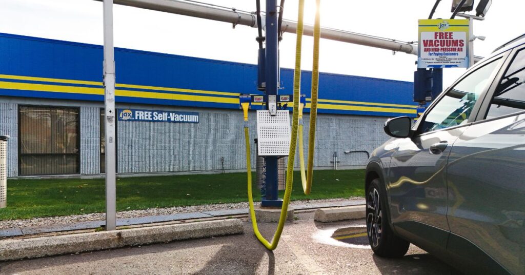 Self-vacuum station with Jax signage and vehicle.