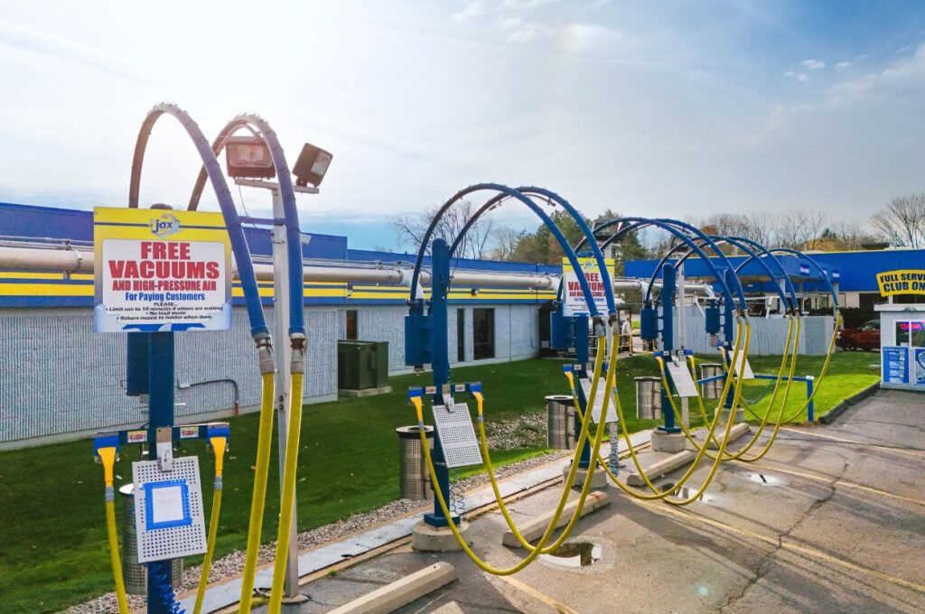 Self-vacuum stations with signage at Jax Car Wash.