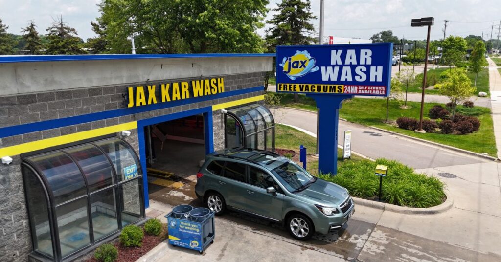 Jax Kar Wash entrance with SUV exiting bay