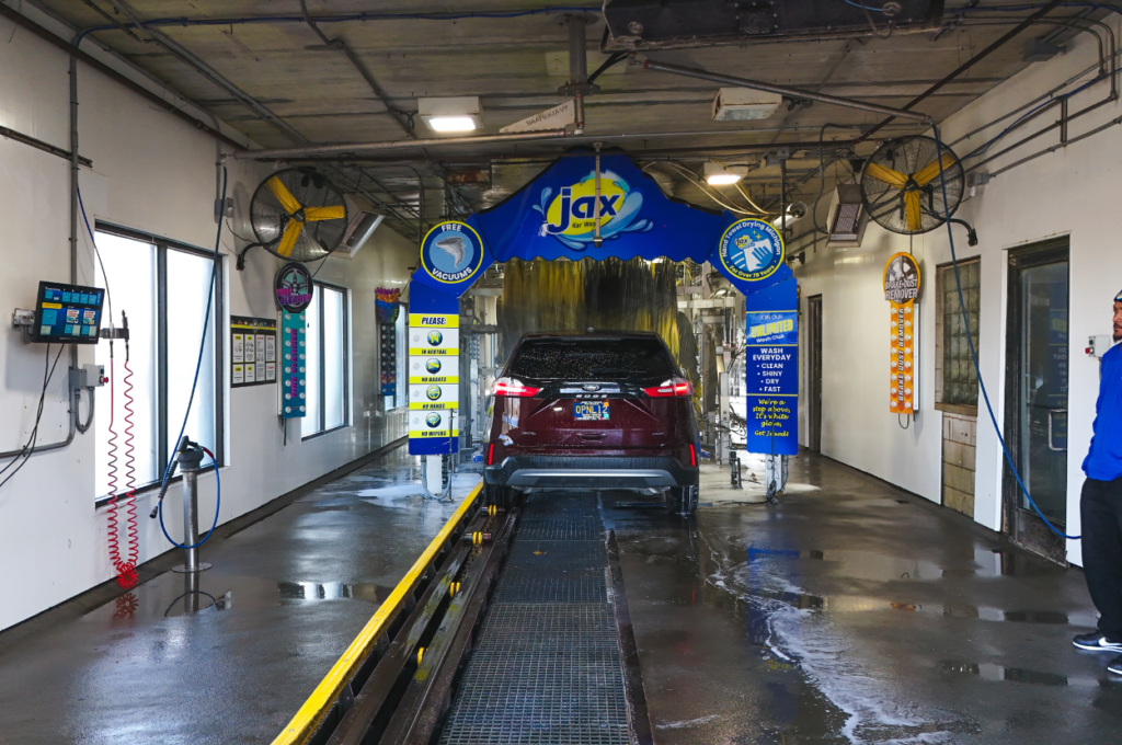 Car entering Jax Kar Wash tunnel for cleaning.