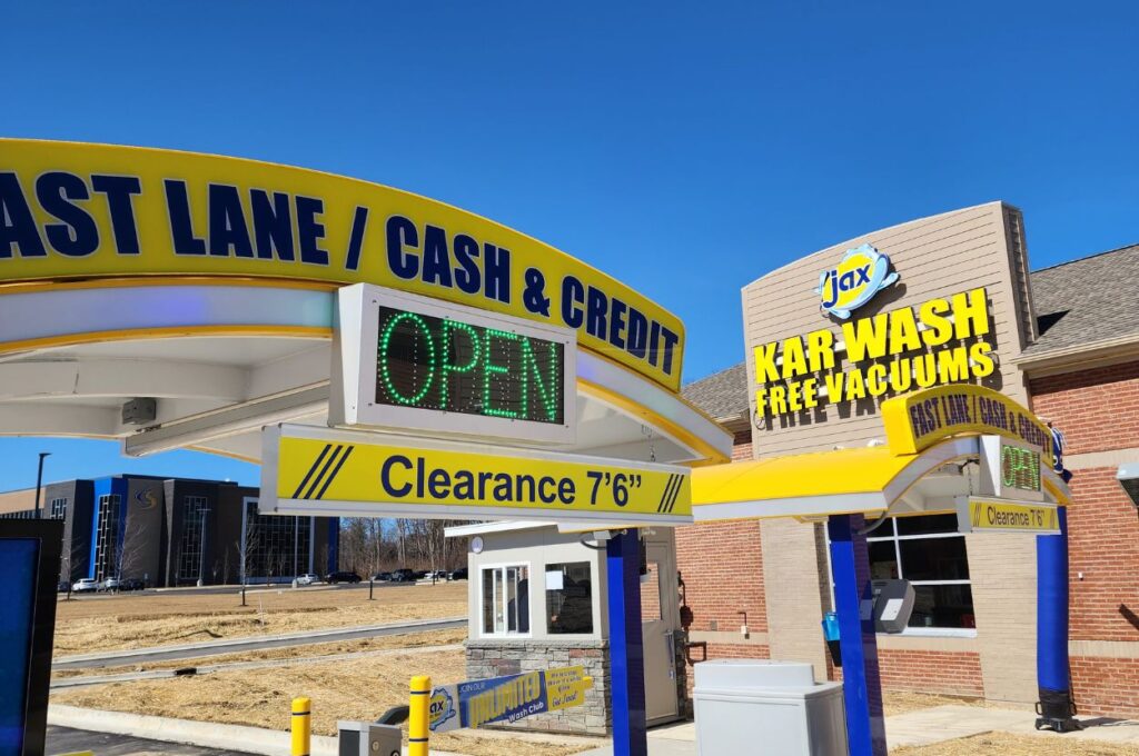 Jax Kar Wash entrance signs with open lane display.
