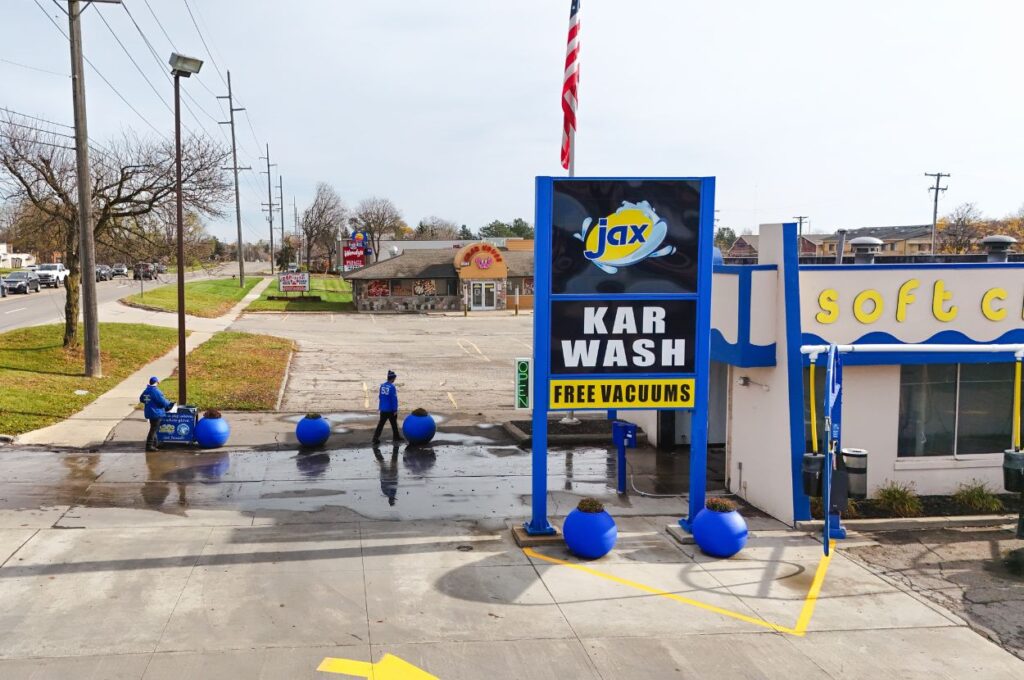 Jax Kar Wash sign and lot with staff.