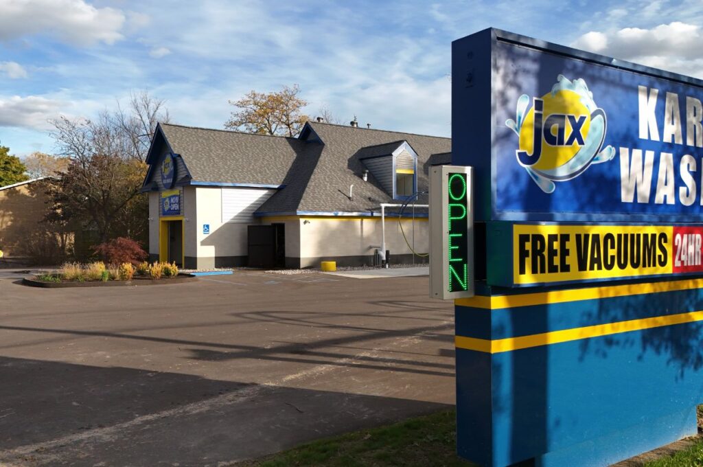 Jax car wash sign with open indicator and building