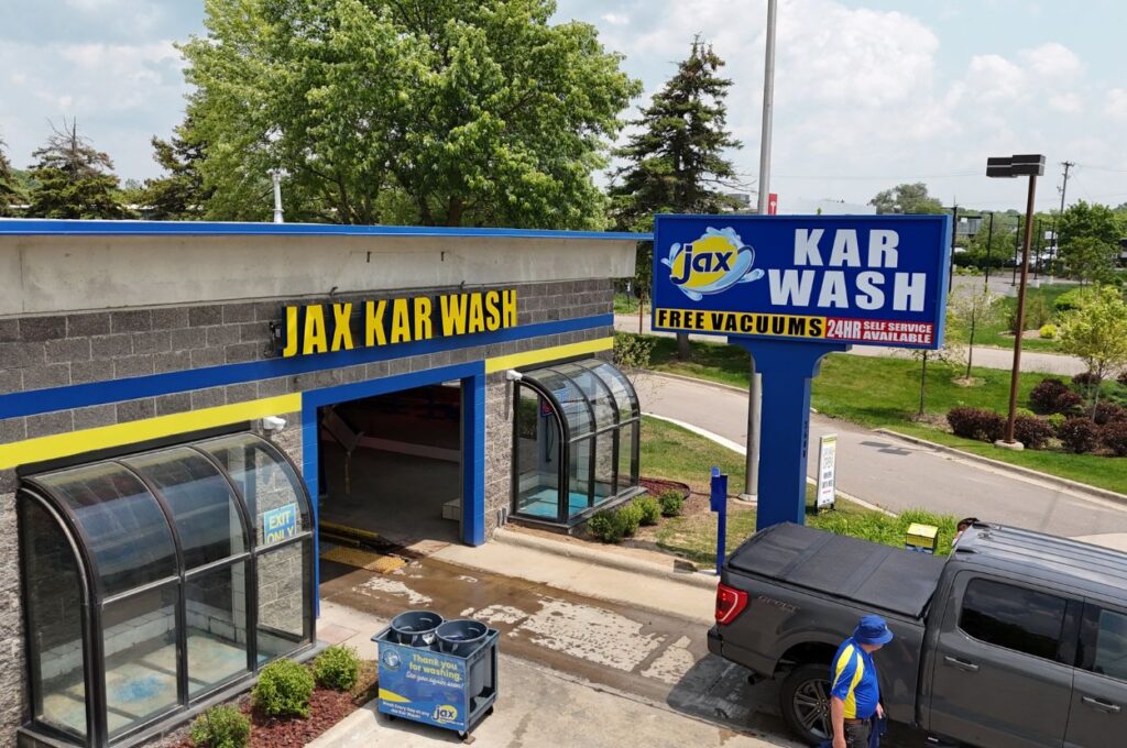Jax Kar Wash entrance with signage and truck outside