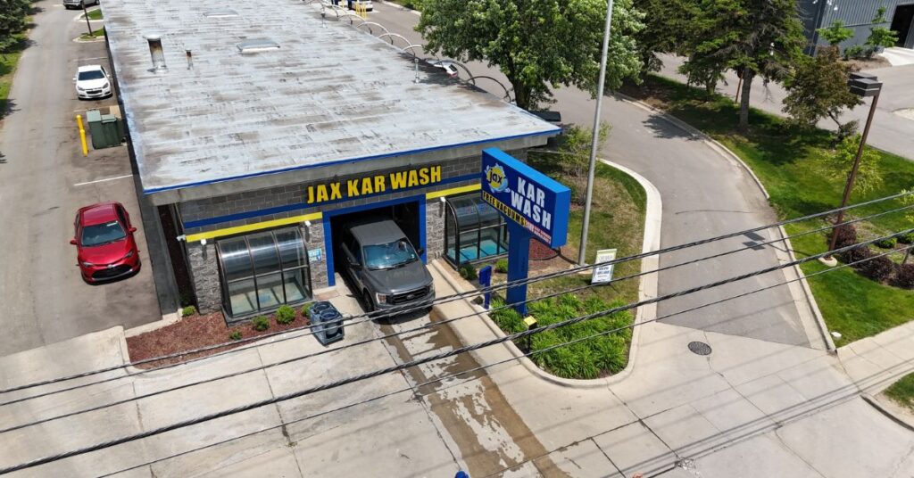 Aerial view of Jax Kar Wash with car exiting tunnel