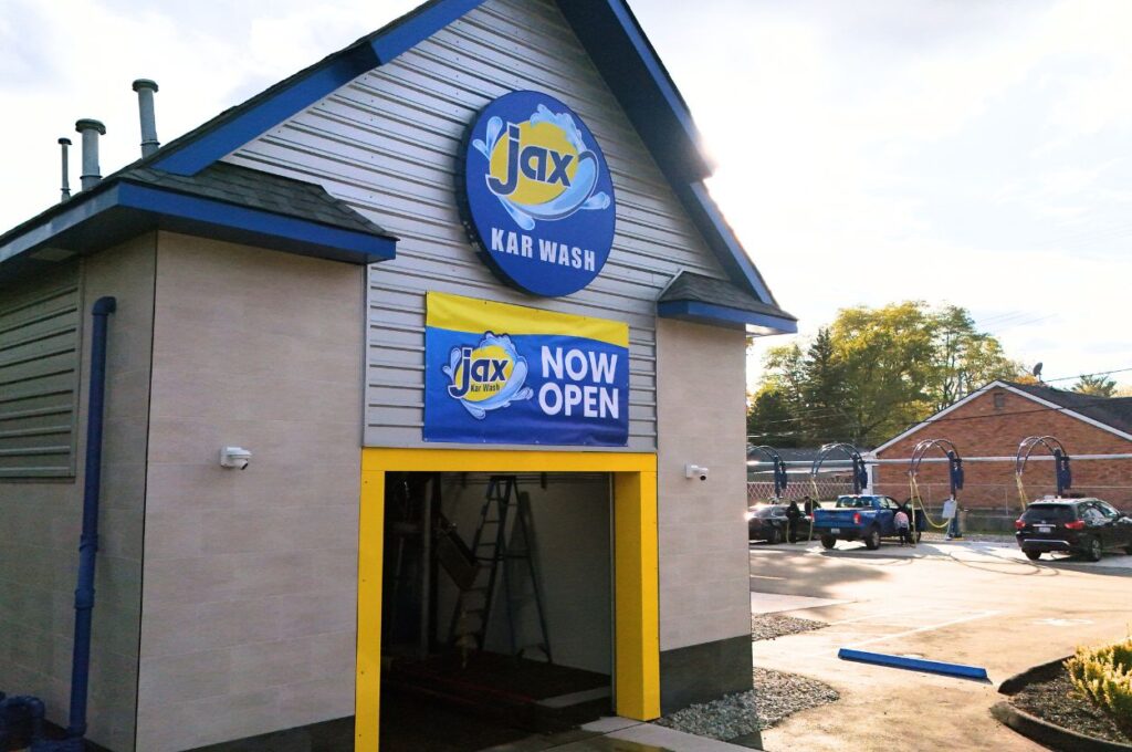 Jax car wash exterior with now open banner displayed