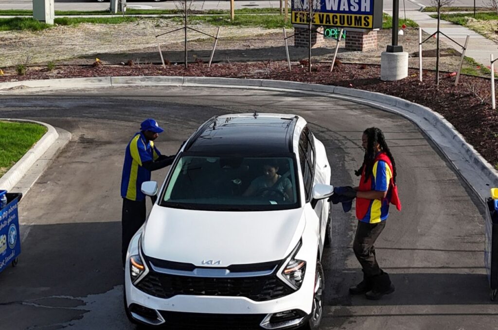 Jax Kar Wash staff assisting customer before vehicle wash