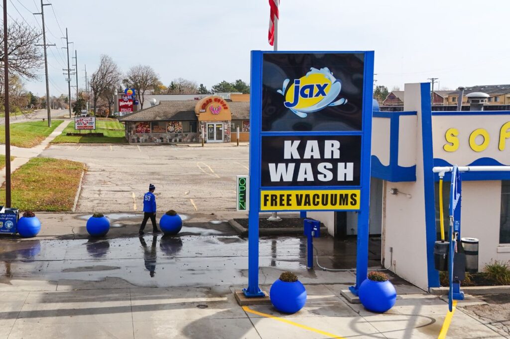 Jax Kar Wash location sign featuring free vacuum services