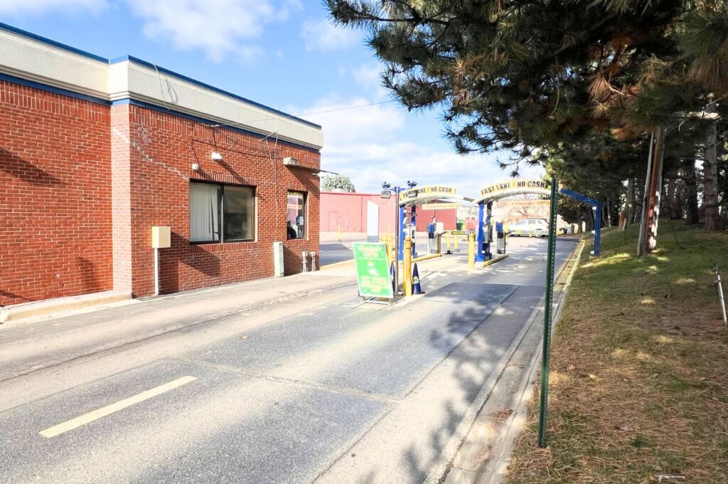 Jax Kar Wash drive-through entrance with payment lane stations